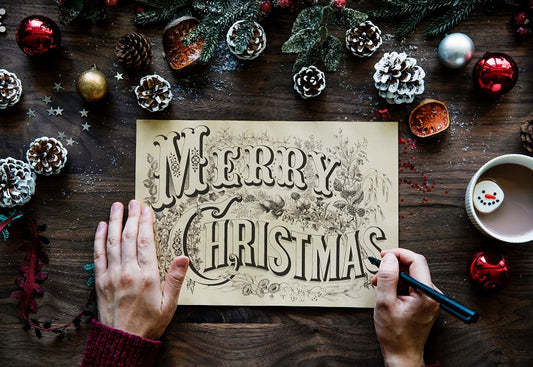 a festive scene with the word merry christmas written on a sign on a christmas themed table