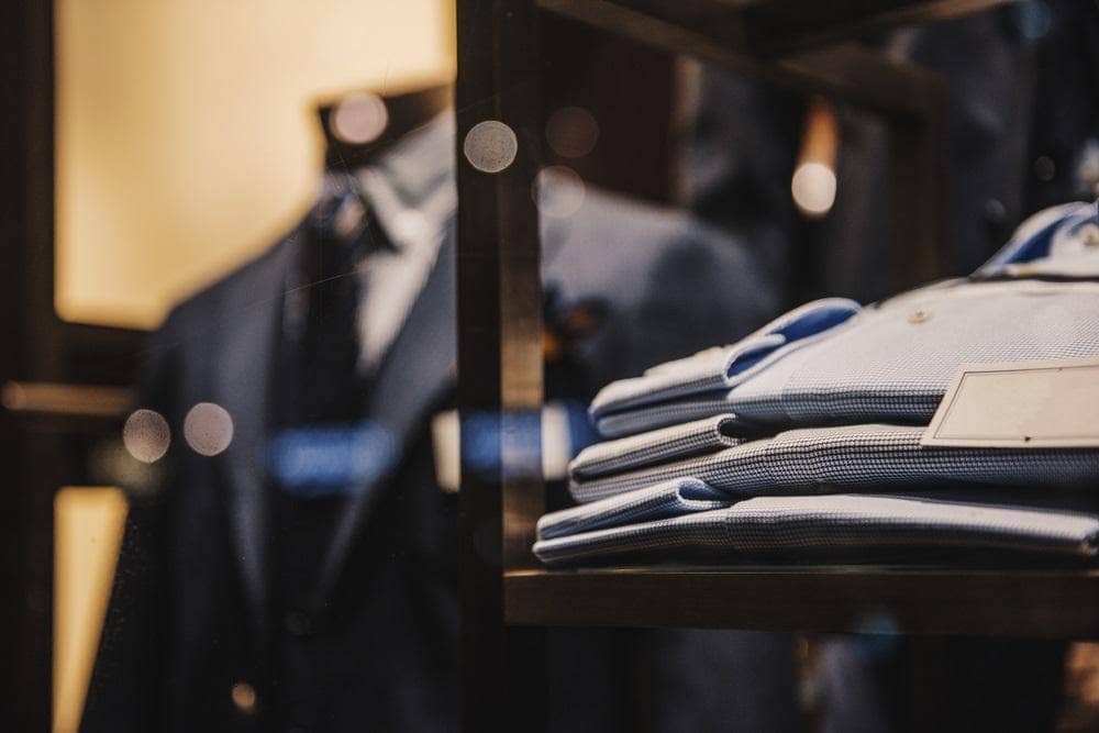 Shirts and suits in a men luxury suit store
