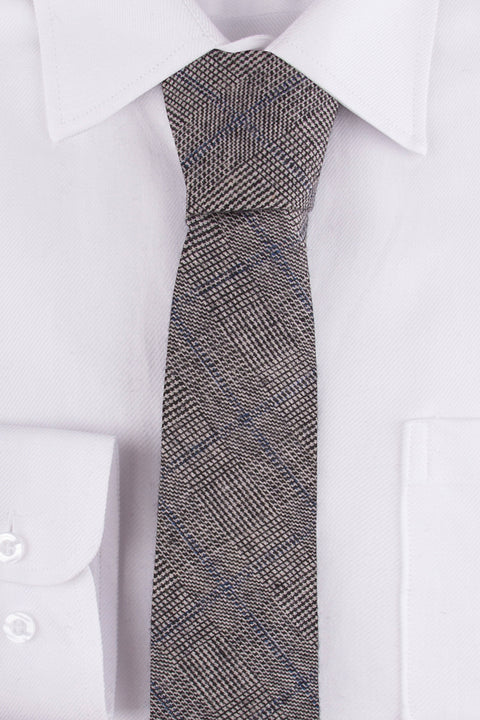 Close up of Grey Blue Prince of Wales Tweed Tie on a single cuff shirt